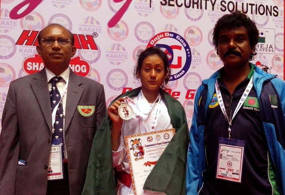 Maun Jera Barna of Bangladesh (centre) showing her silver medal after earning her medal in the Women's minus 48 kg weight category of the 8th Commonwealth Karate Championship held in New Delhi, the capital city of India on Saturday.