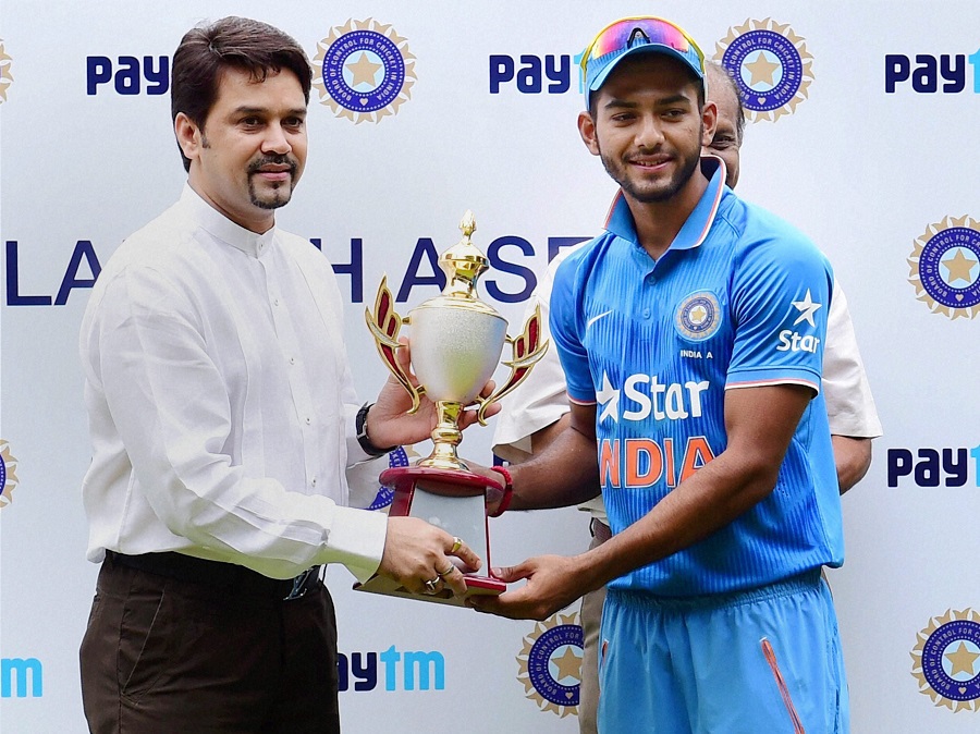 BCCI Secretary Anurag Thakur handing over the winning trophy to India 'A' Skipper Unmukt Chand after they won the 3rd ODI series against Bangladesh 'A' at Chinnaswamy Stadium in Bengaluru on Sunday.
