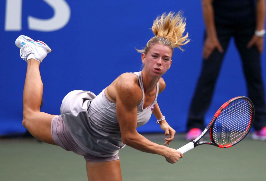 Camila Giorgi of Italy serves to Caroline Garcia of France during a first round match of the Pan Pacific Open womenâ€™s tennis tournament in Tokyo, Monday.