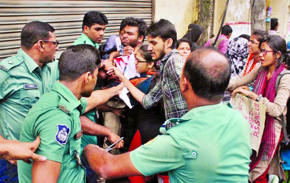 Police charge batons on the agitating students seeking cancellation of MBBS, BDS admission test in front of Jatiya Press Club on Monday.