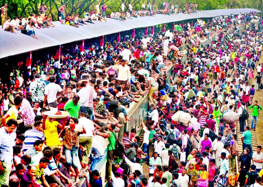 MAD RUSH: A passenger-train being overcrowded by thousands of home-bound passengers at Airport Rly Station on Wednesday.