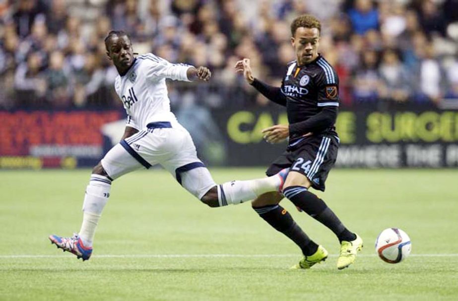 Vancouver Whitecaps' Darren Mattocks (left) loses the ball to New York City FC's Shay Facey during the first half of an MLS soccer match in Vancouver, British Columbia on Saturday.