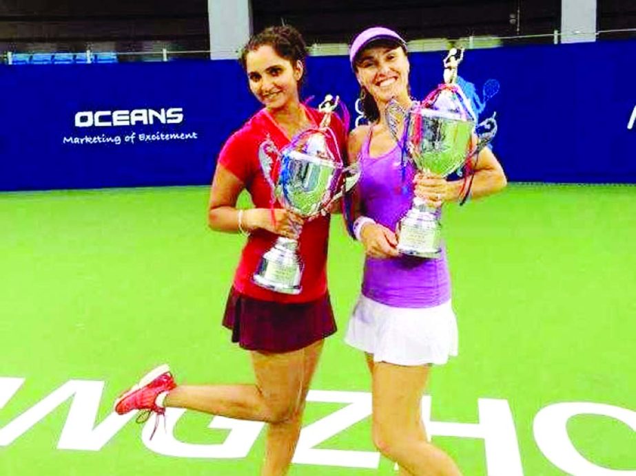 Sania Mirza and Martina Hingis with Guangzhou Open trophies on Sunday.