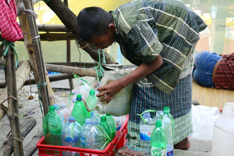 Hawkers are seen to sell bottles of water in launches taking from WASA line .The snap was taken from Sadarghat Launch Terminal in the city on Monday.