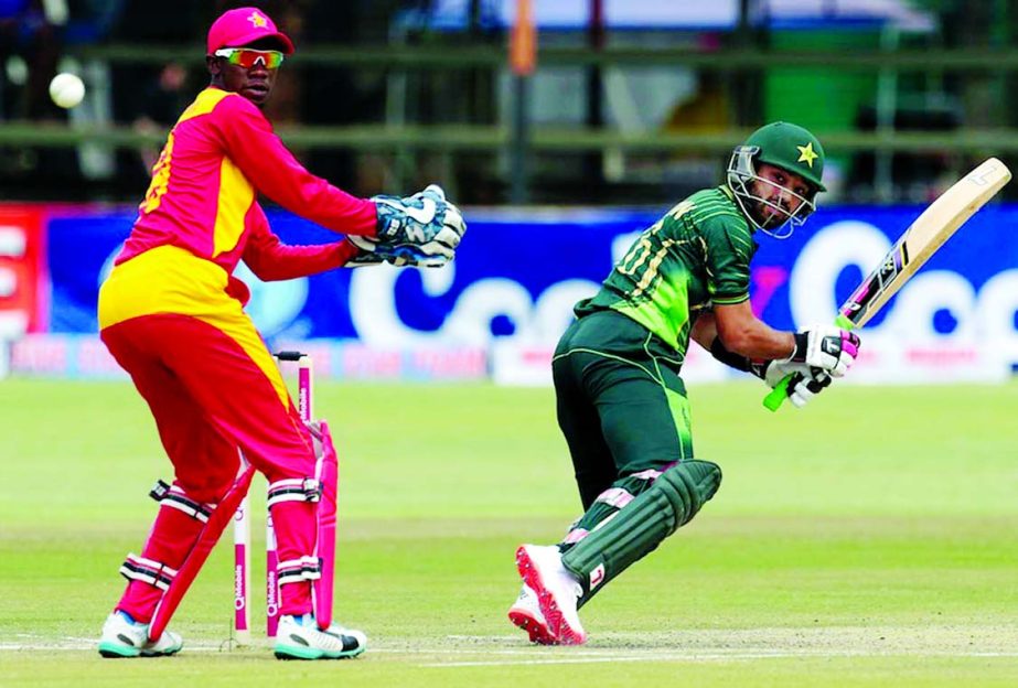 Pakistan's batsman Muhammad Rizwan (R) prepares to play a shot next to Zimbabwe's wicketkeeper Richmond Mutumbami during the second of two T20 cricket matches between Zimbabwe and Pakistan at Harare Sports Club on Tuesday.