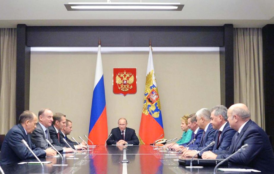 Russian President Vladimir Putin, centre, listens as he meets with members of Russia's Security Consul in the Novo-Ogaryovo residence outside Novo-Ogaryovo, Russia, on Tuesday.