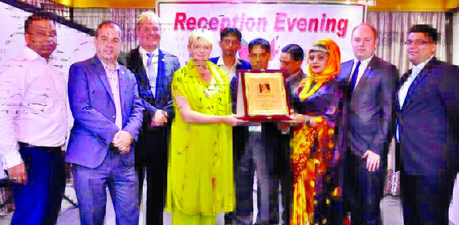 Chief of the British Parliamentary Group Anne Main presenting crest to the Chairman of Joyjatra Foundation Sister Helena Zahangir at a hotel in the city on Tuesday for her contribution in social development. Conservative Friends of Bangladesh organized t