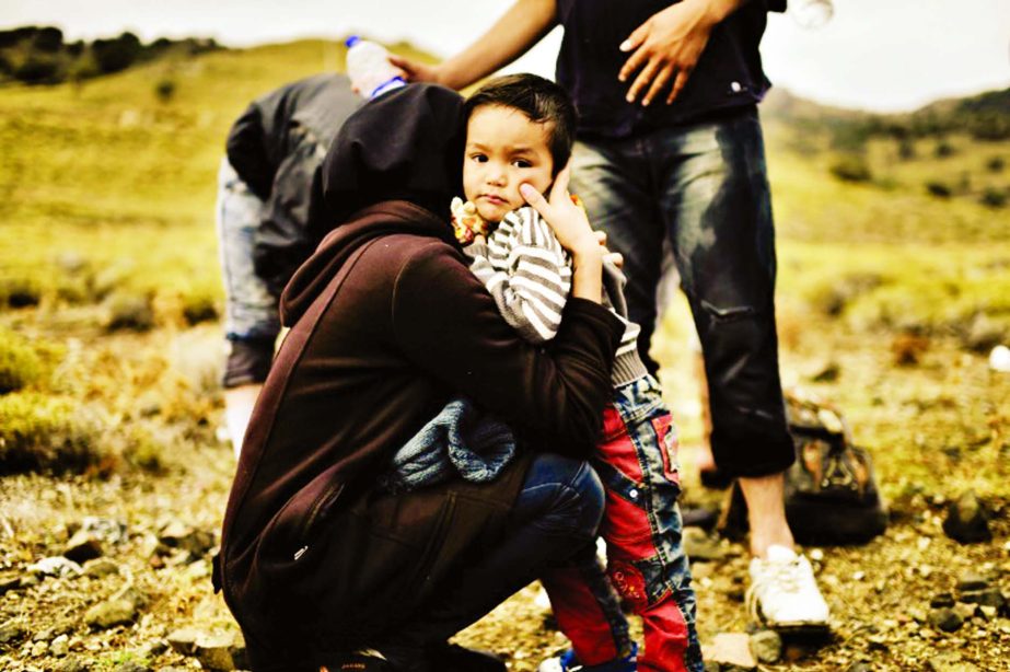 A woman embraces her child upon their arrival with other refugees and migrants to the Greek island of Lesbos after crossing the Aegean Sea from Turkey.