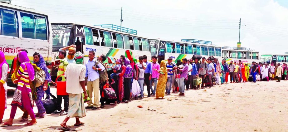 Transport crisis: Hundreds of people crossed the Padma River waiting in long queue to board a bus after celebrating Eid festival. This photo was taken from Mawa Ghat on Friday.
