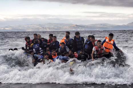 Refugees and migrants arrive at the Greek island of Lesbos after crossing the Aegean sea from Turkey on Friday.