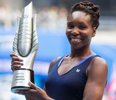 Venus Williams of the United States poses with her trophy after winning the final of women's singles against Garbine Muguruza of Spain at 2015 WTA Wuhan Open Tennis Tournament in Wuhan, capital of central China's Hubei Province on Saturday. Venus Willia