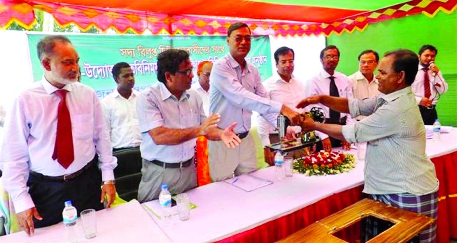Swapan Kumar Roy, General Manager of Bangladesh Bank inaugurating the investment of Islami Bank Ltd to former enclave dwellers at the Bhurungamari Branch in Kurigram on Saturday.