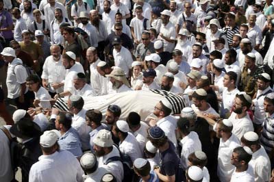 Friends and relatives carry the body of 41-year-old Israeli Nechamia Lavi, who was killed when he rushed to help victims of a knife attack carried out by a Palestinian man, during his funeral ceremony at the Jerusalem cemetery.