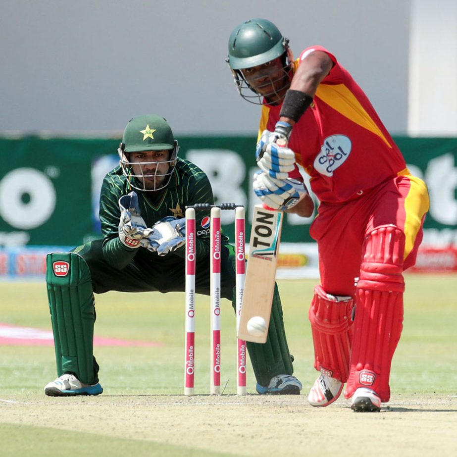 Zimbabwe's batsman Chamunorwa Chibhabha plays a shot as wicket keeper Sarfraz Ahmed looks on during the final game of a three ODI cricket matches between Zimbabwe and Pakistan at the Harare Sports Club on Monday.