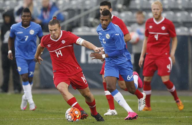 Canada midfielder Sam Petite (left) picks up a loose ball in front of Cuba defender Yosel Piedra during the first half of a CONCACAF Olympic qualifying soccer match on Tuesday in Commerce City, Colo. The teams played to a 2-2 tie.