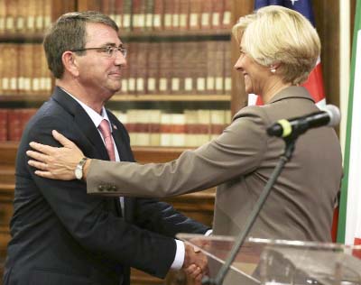 Italian Defence Minister Roberta Pinotti, right, and US Secretary of Defence Ashton Carter shake hands at the end of joint press conference on the occasion of their bilateral meeting, in Rome on Wednesday