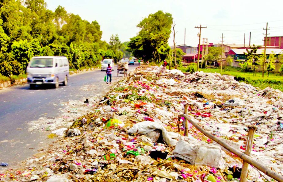 A portion of busy Dhaka-Aricha Highway being occupied by locals, dumping waste and garbage creating obstacle to ply heavy vehicles thru' narrow road causing sufferings to commuters. But the authorities don't care to resolve the problems. This photo was