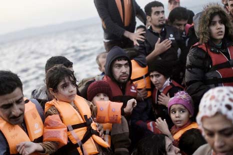 Refugees and migrants arrive at Lesbos island after crossing the Aegean Sea from Turkey on Thursday.