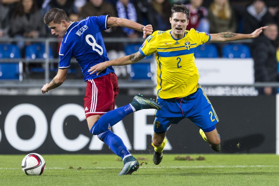 Liechtenstein's Sandro Wieser (left) and Sweden's Mikael Lustig (right) challenge for the ball during the Euro 2016 qualifying group G soccer match between Liechtenstein and Sweden at the Rheinpark Stadium in Vaduz, Liechtenstein on Friday.