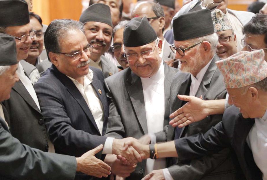 Nepal's former Prime Minister Sushil Koirala, centre right, newly elected PM and Communist Party of Nepal-Unified Marxist Leninist leader Khadga Prasad Oli, centre, and Communist Party of Nepal (Maoist) Chairman Pushpa Kamal Dahal, centre left, shake han