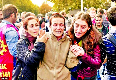 Distraught: A woman mourns for victims as her friends comfort her during a demonstration one day after the double explosion in Ankara. Internet photo