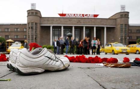 A pair of shoes, belonging to a street vendor who was selling Turkish traditional bagel or simit, is placed at the bombing scene during a commemoration for the victims of Saturday's bomb blasts, in Ankara, Turkey.