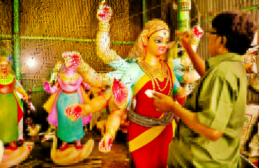 Sculptor engaged in painting idols five-day ahead of holy Durga Puja, the largest religious festival of the Hindu community. The snap was taken from a temple in the city's Banglabazar area on Monday.