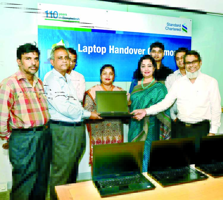 Babul Krishna Saha, Head Master of Kashipur Adorsho Girls High School receiving laptops from Bitopi Das Chowdhury, Head of Corporate Affairs and Monitur Rahman Head of Technology Standard Chartered Bangladesh at the bank's head office recently.