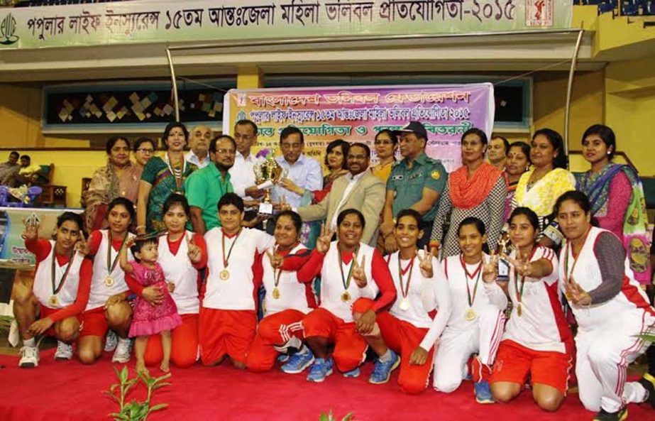 Members of Rajshahi district team, the champions of the Popular Life Insurance 15th Inter-District Women's Volleyball Competition and the guests and officials of Bangladesh Volleyball Federation pose for a photo session at the Shaheed Suhrawardy Indoor S