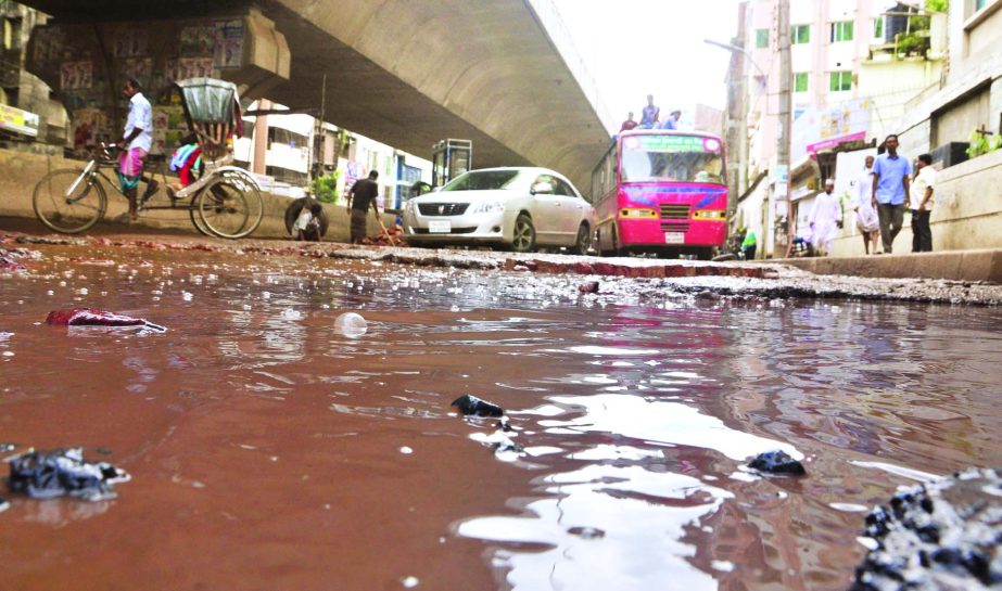 Commuters and pedestrians experienced untold sufferings as potholes and ditches on roads made their movement difficult following the short spell of rains. This photo was taken from Joykali Mandir area adjacent to Hanif Flyover on Wednesday.