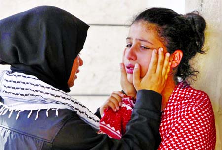 A relative of 27-year-old Palestinian Mutaz Zawahereh, who was killed by Israeli troops during clashes on Tuesday, is comforted as she mourns during his funeral in the West Bank city of Bethlehem on Wednesday. Internet photo