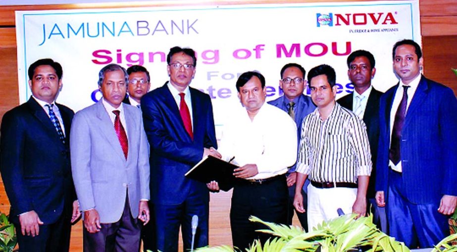 AKM Saifuddin Ahamed, Deputy Managing Director of Jamuna Bank and AKM Faruk Ahmed, Chairman and Managing Director of NOVA Electronics sign an agreement at the bank's head office in the city recently. Under this agreement all the employees of the bank and