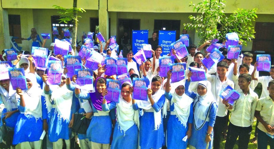 Students of Paschim Sadar High School of a workshop on "Safe Internet"" organised by Grameenphone poses with the Safe Internet Leaflets in Sylhet on Thursday."