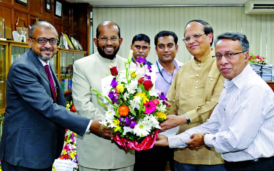 Md Habibur Rahman, Managing Director of Al-Arafah Islami Bank Ltd, congratulating Bangladesh Bank Governor Dr Atiur Rahman for achieving the award of 'Central Bank Governor of the Year for Asia 2015' at his office on Thursday. Bangladesh Bank's GM AFM