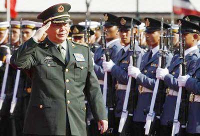 China's Defence Minister Chang Wanquan, accompanied by Thailand's Deputy Prime Minister and Defence Minister Prawit Wongsuwan (not pictured), reviews a guard of honour during his visit to Thailand