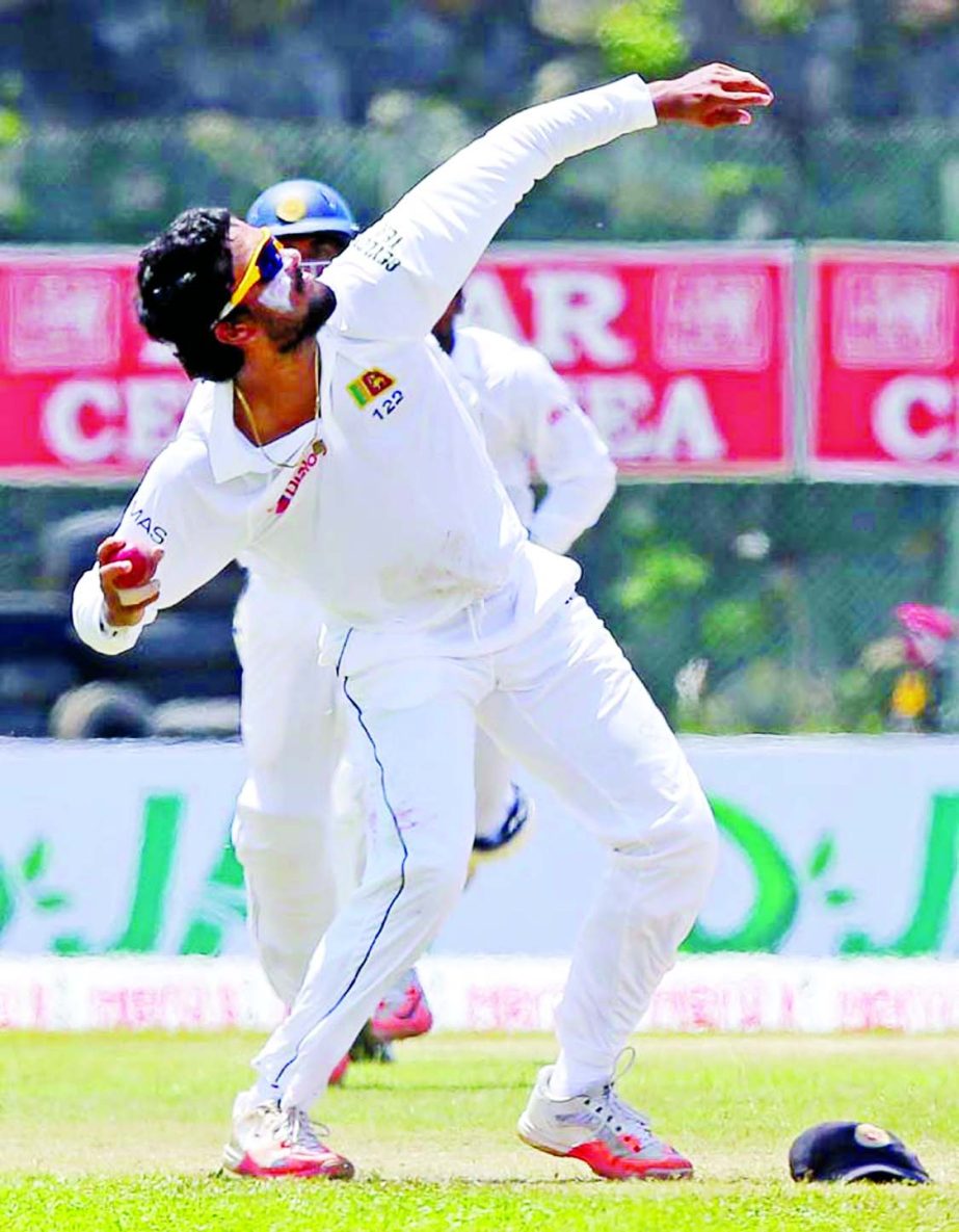 Sri Lanka's Dinesh Chandimal celebrates after successfully taking a catch to dismiss West Indies' batsman Darren Bravo during the third day of the first Test cricket match in Galle, Sri Lanka on Friday.