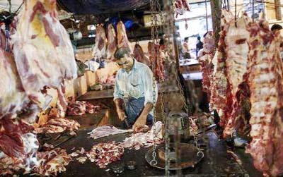 A butcher cuts up portions of beef for sale in an abattoir at a wholesale market in Mumbai, India.