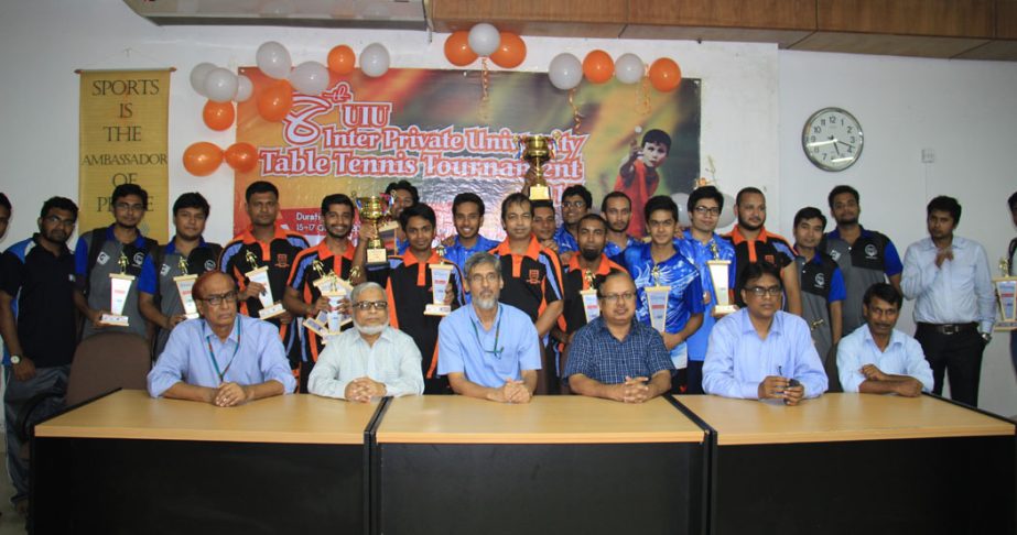 The winners of the Inter-Private University Table Tennis Tournament and the teachers of United International University (UIU) pose for photographs at the Auditorium of UIU on Saturday.