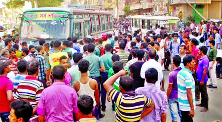 Transports came to a halt in city streets and its suburb from yesterday noon as bus operators stopped plying their vehicles following the fining of several buses by a BRTA mobile court for charging extra fare from passengers. Picture shows helpless commut