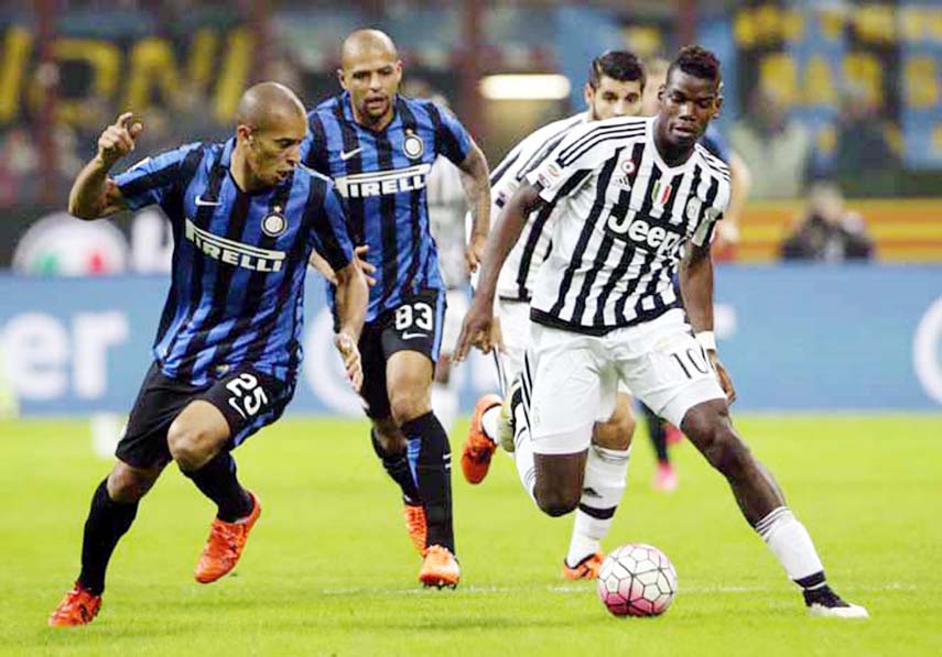 Juventus' Paul Pogba (right) challenges for the ball with Inter Milan's Miranda during a Serie A soccer match between Inter Milan and Juventus at the San Siro stadium in Milan, Italy on Sunday.