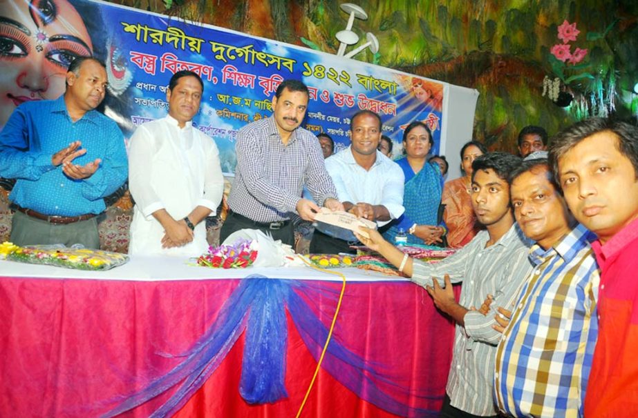 CCC Mayor AJM Nasir Uddin distributing scholarships among the meritorious students of Hindu Community on the occasion of Durga Puja in the city yesterday.