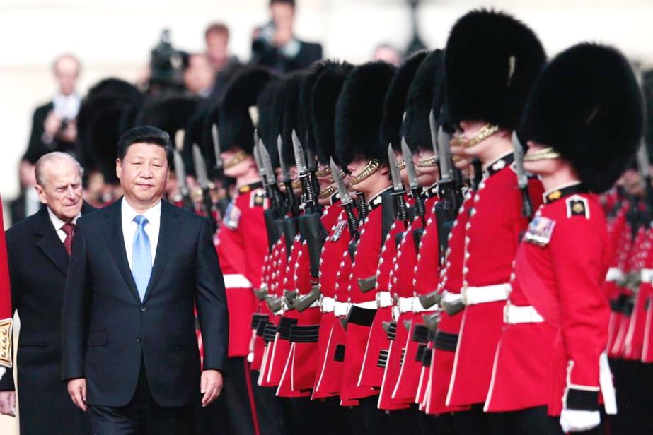 China's President Xi Jinping and Britain's Prince Philip review an honour guard during his official welcoming ceremony in London, Britain.