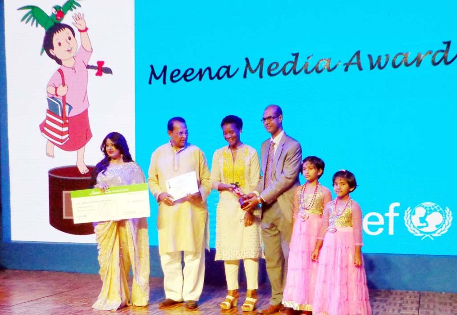 Dr Binoy Barman, Director of Daffodil Institute of Languages receives the 11th Meena Media Award 2015 from Deputy Representative of UNICEF Bangladesh Louise Mvono. Information Minister Hasanul Haq Inu is also seen in the picture.