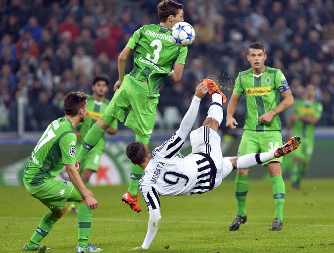 Juventus' Alvaro Morata, (number 9) goes for an acrobatic kick during the Champions League, group D soccer match between Juventus and Borussia Moenchengladbach at the Juventus Stadium in Turin, Italy on Wednesday.