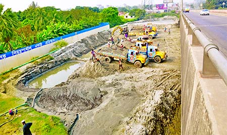 Illegal extracting of sands from areas near the Sultana Kamal Bridge on Dhaka-Sylhet Highway continues unabated as the concerned authorities keep their eyes shut due to vested interest. This photo was taken on Thursday.