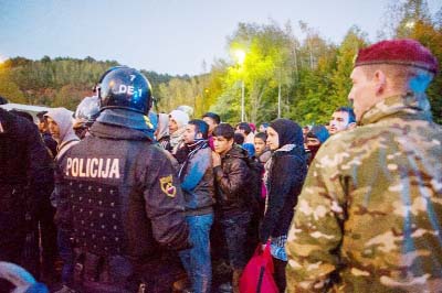 Migrants walk to a refugee center in Sentilj, on the Slovenian-Austrian border.