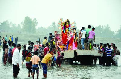 DINAJPUR: Members of Hindu Community immersion idols in Punorbhoba River at Sadurghat area on Friday.