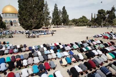 Palestinian Muslim worshipers pray outside the Dome of the Rock at the Al-Aqsa Mosque compound in Jerusalem during Friday prayers.