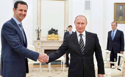 Russian President Vladimir Putin, right, shakes hand with Syria President Bashar Assad in the Kremlin in Moscow, Russia.