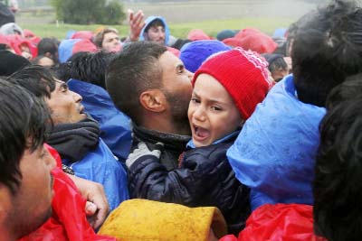 A child cries as migrants scuffle with policemen to cross the border with Slovenia near Trnovec, Croatia.